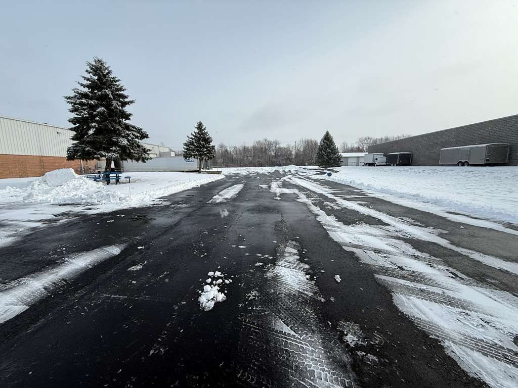 Business park access lane plowed down to bare asphalt