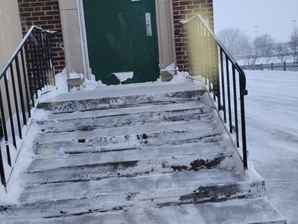 Commercial building entrance steps and railings cleared of snow