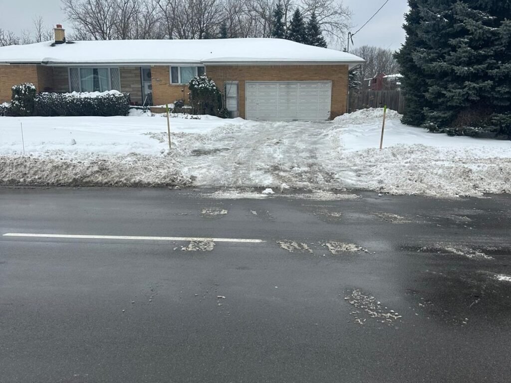 Driveway apron cleared of snow all the way out to the road